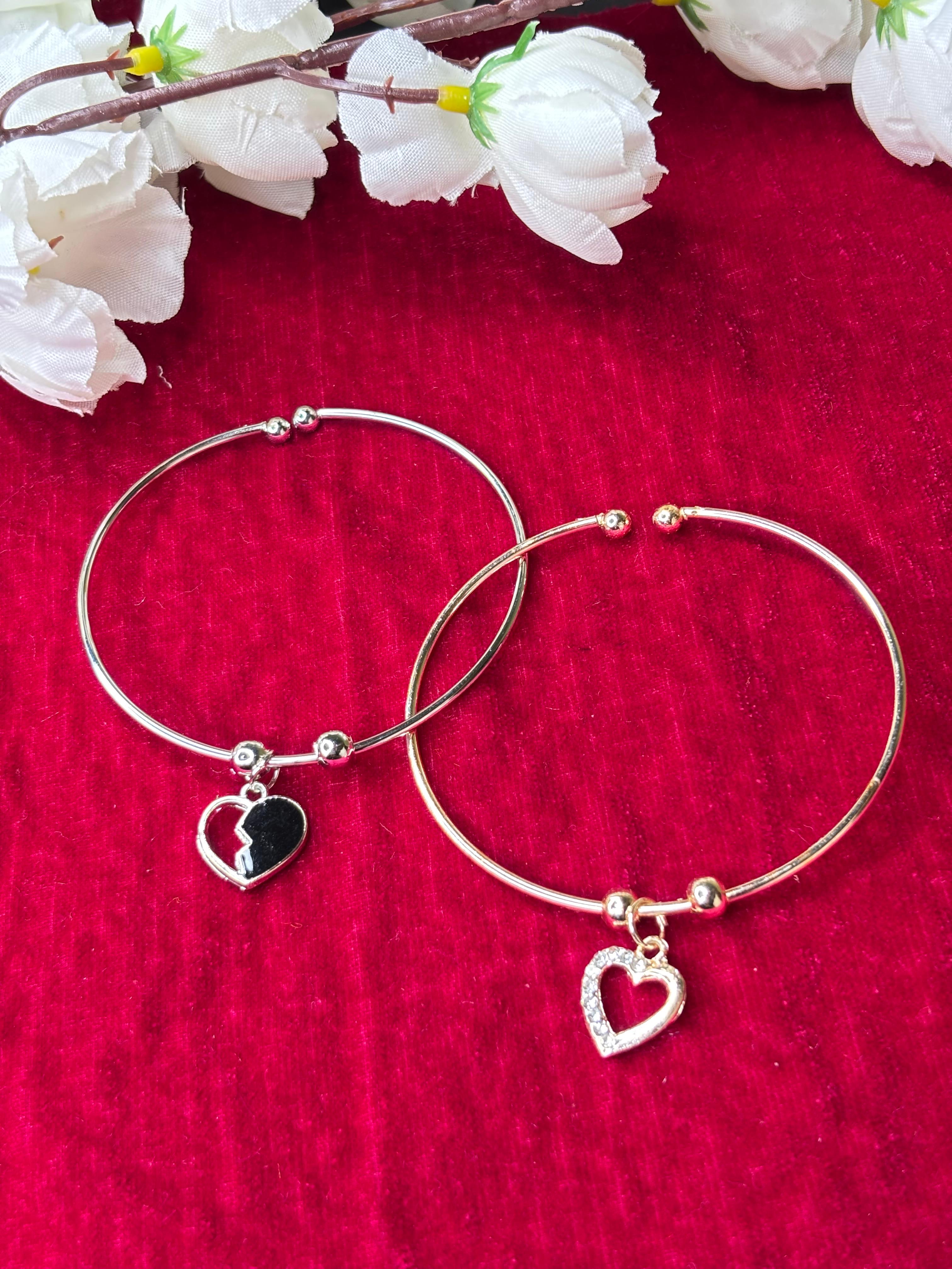 Pair of Gold and silver plated bracelet with heart charm